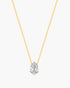 Gold necklace with a clear teardrop-shaped pendant on a white background